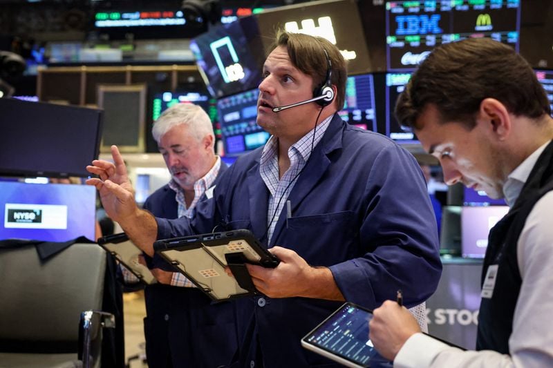 Wall Street closes lower as oil prices jump, indexes notch monthly gains